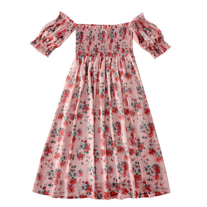 Family matching off-shoulder summer dresses in blue, worn by a mother and her young daughter.