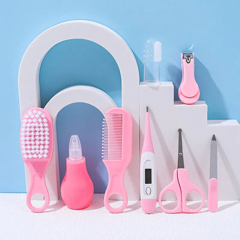 Close-up of baby health care kit tools: soft-bristle brush, comb, and nasal aspirator