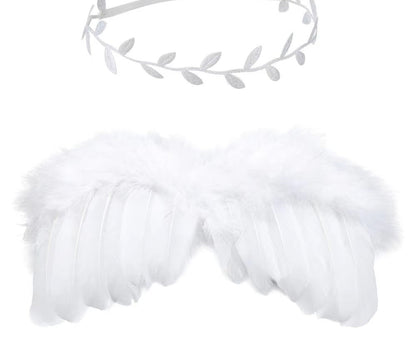 Infant photography focus: close-up on angel feather wings and intricate flower headband detail