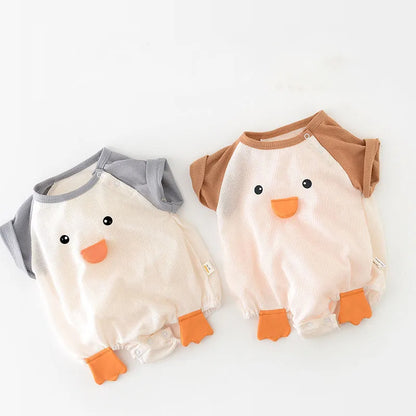 Newborn baby boy in a plain white short sleeve cotton bodysuit, comfortable and soft infant apparel.