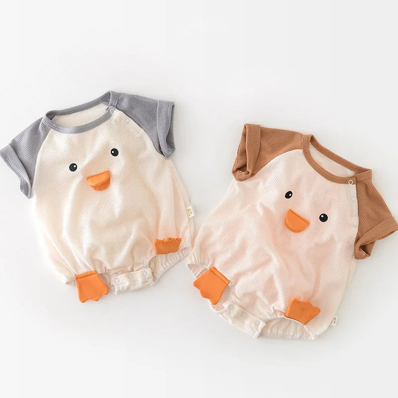Infant girl wearing a light pink cotton short sleeve onesie, perfect for summer baby clothes.