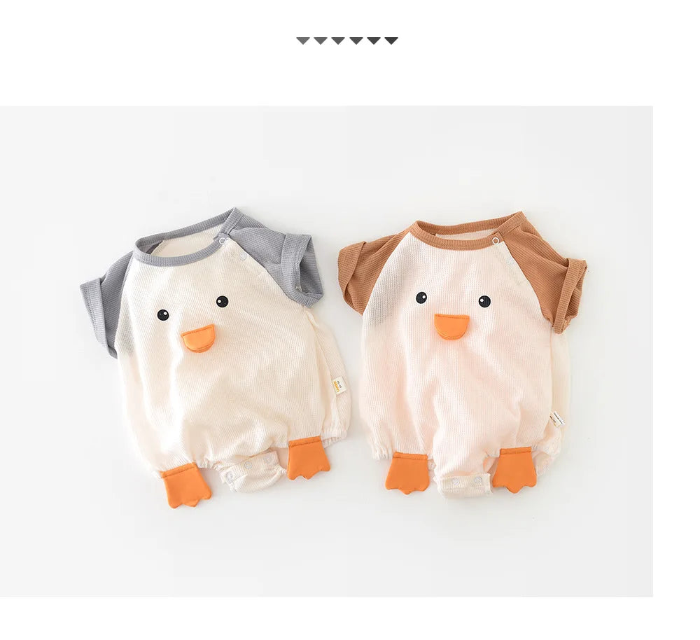 Baby laying on a blanket wearing a short sleeve cotton bodysuit, showcasing mobility and comfort.