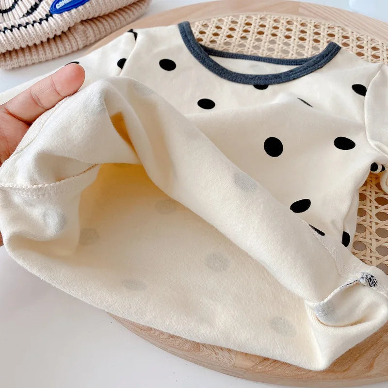 Infant wear: white cotton long-sleeve top and blue cotton pants, a cozy baby outfit set.