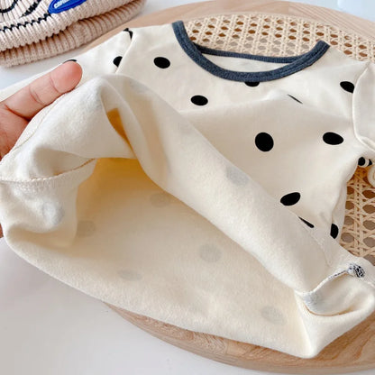 Infant wear: white cotton long-sleeve top and blue cotton pants, a cozy baby outfit set.
