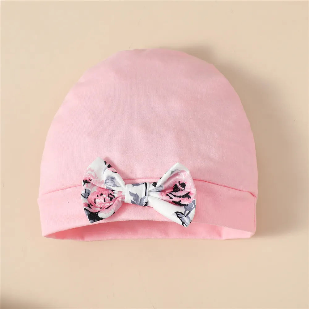 Newborn baby girl floral print cotton blend romper with matching hat.