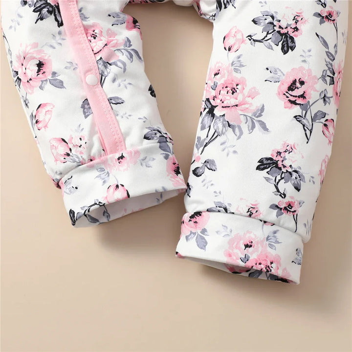 Floral pattern baby girl romper with matching hat, a cozy cotton blend set.