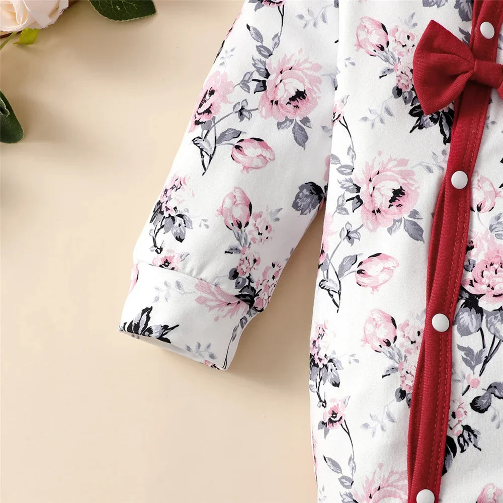 Newborn baby girl's floral long sleeve romper and matching beanie hat.