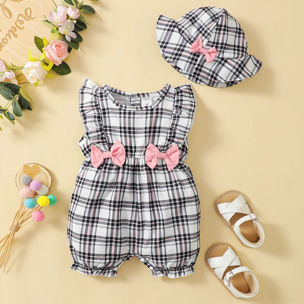 Infant girl in a casual plaid romper, illustrating comfortable and cute baby clothes for summer.