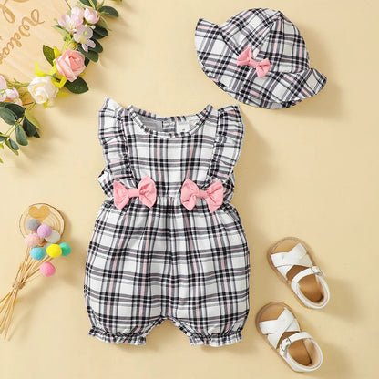 Infant girl in a casual plaid romper, illustrating comfortable and cute baby clothes for summer.