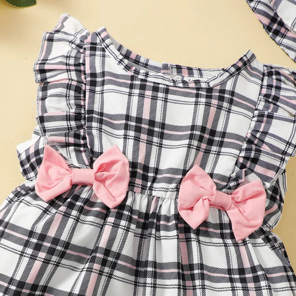 This summer outfit for baby girls features a vibrant plaid pattern on a sleeveless romper.
