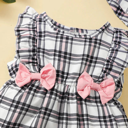 This summer outfit for baby girls features a vibrant plaid pattern on a sleeveless romper.