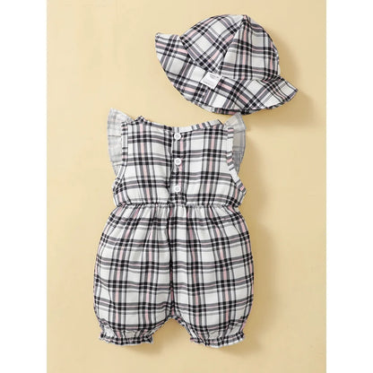 Close-up of the fabric on a baby girl's plaid romper, highlighting the quality polyester material.