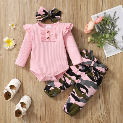 Newborn baby girl in cozy pink 3-piece outfit set, perfect for infants.