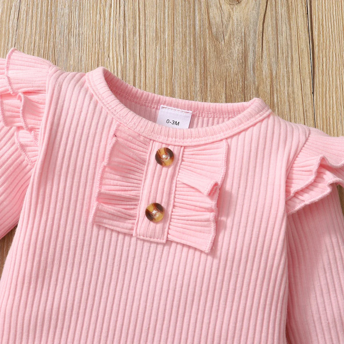 Cute baby clothes: pink infant top with matching pants and coat for newborn girls.
