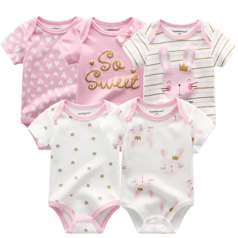 Close-up of a baby girl's white cotton short sleeve bodysuit with delicate trim