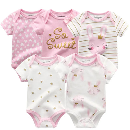 Close-up of a baby girl's white cotton short sleeve bodysuit with delicate trim