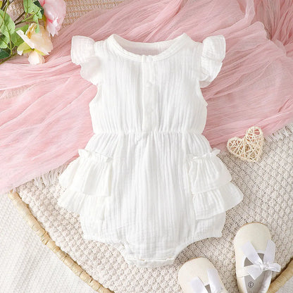 Newborn baby girl in white cotton halter dress with delicate lace trim, perfect infant summer outfit.