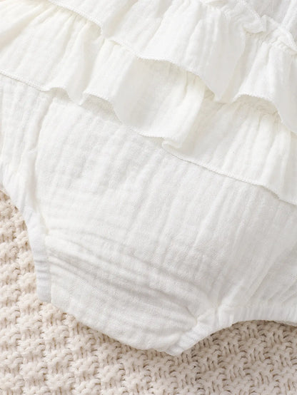 Soft white halter dress for newborn baby girls, a perfect and comfortable infant summer clothing option.