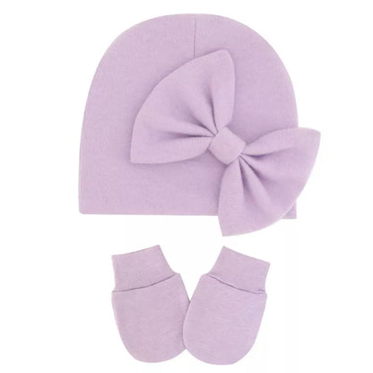 Close-up of the soft texture on a newborn baby girl's cotton hat.