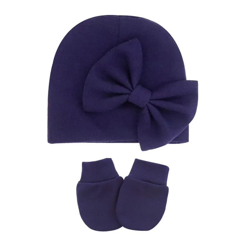 Cute baby girl's cotton hat and mittens, styled for comfort and warmth.