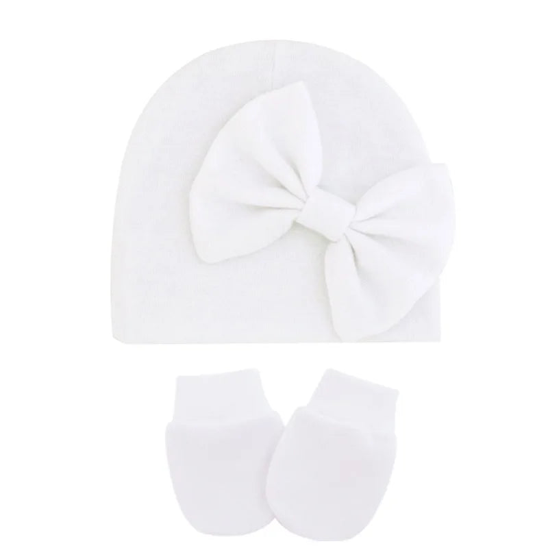 Soft pink cotton set, including a newborn hat and two mittens for baby girls.