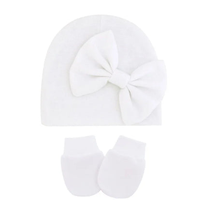Soft pink cotton set, including a newborn hat and two mittens for baby girls.