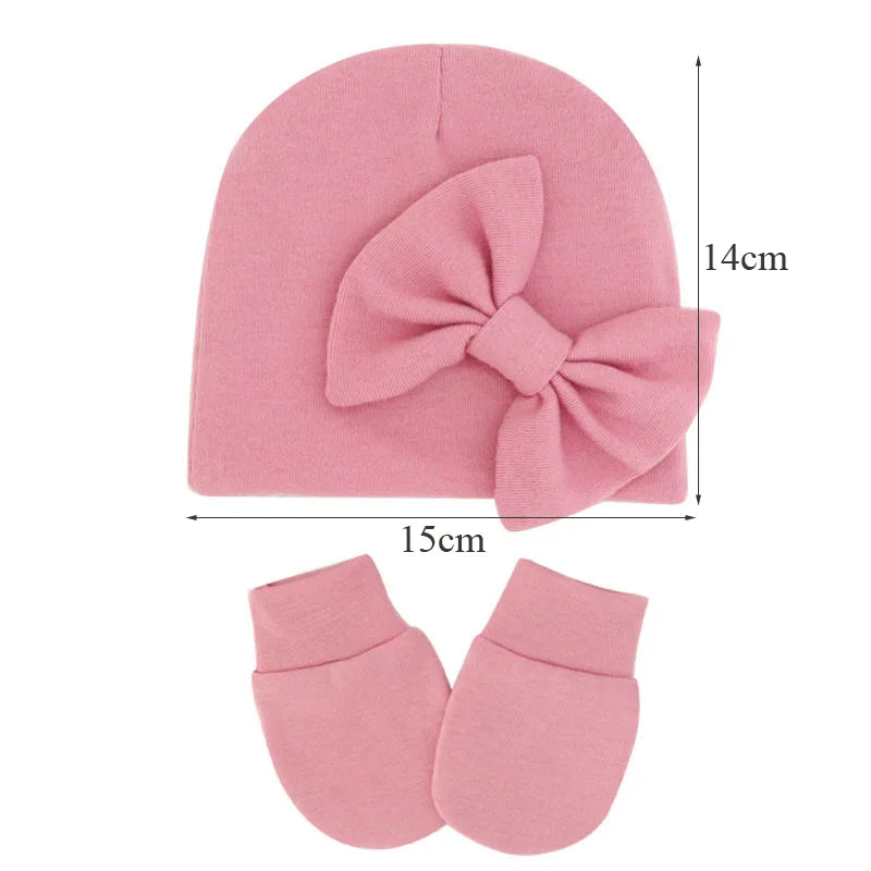 Cute baby gift: newborn girl's cotton hat with bow and matching mittens.