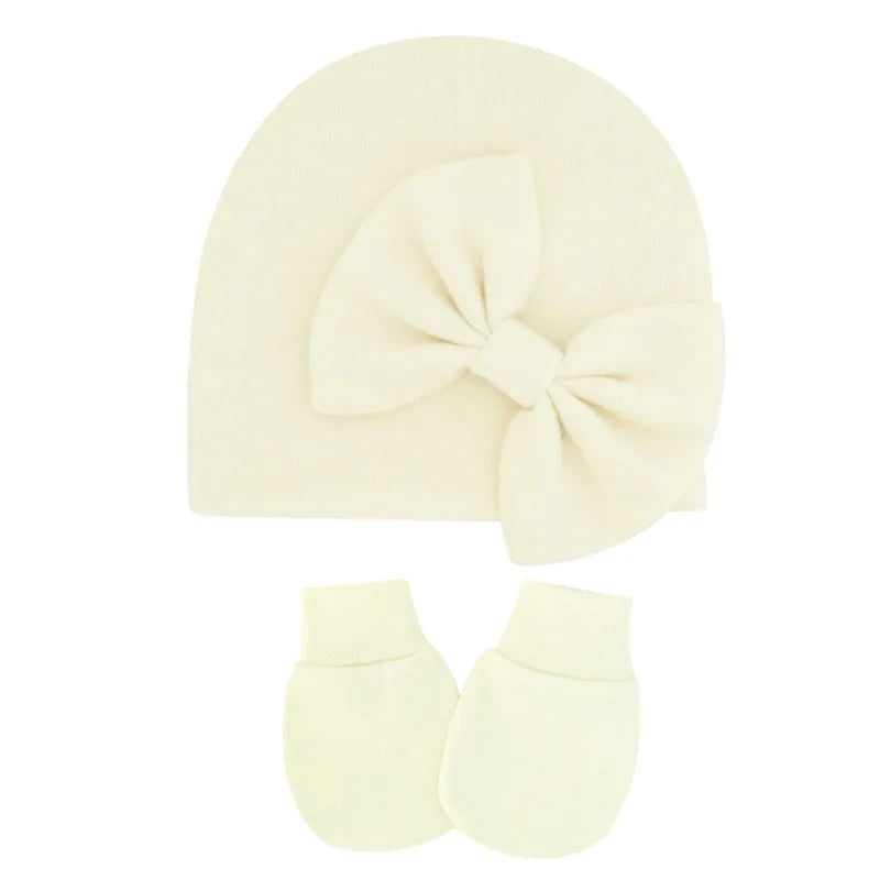 Newborn essentials: soft cotton hat and mittens, perfect for baby girl gifts.