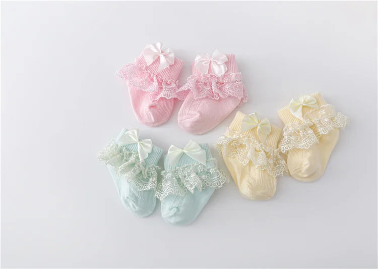 Baby girl's white cotton blend lace socks with a perfectly tied princess bow, infant wear