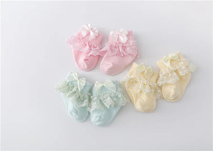 Baby girl's white cotton blend lace socks with a perfectly tied princess bow, infant wear