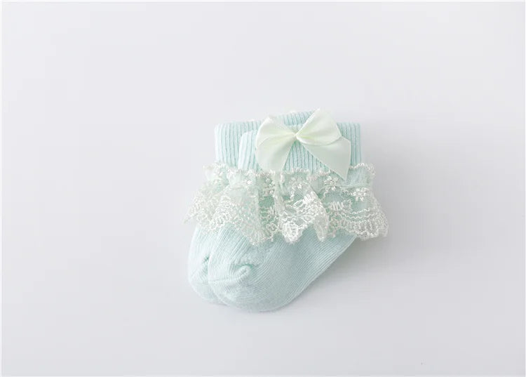Fashionable baby socks for girls, featuring ornate lace and a stylish princess bow