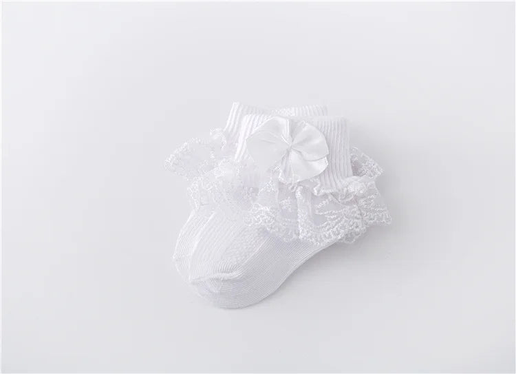 Detail shot of the quality lace and satin princess bow on baby girl's socks