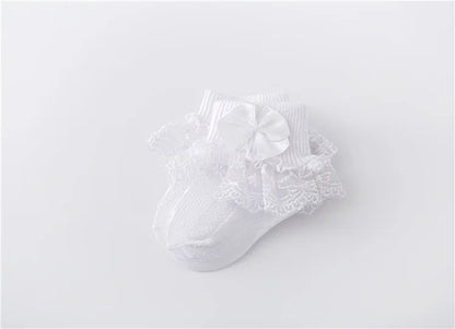 Detail shot of the quality lace and satin princess bow on baby girl's socks