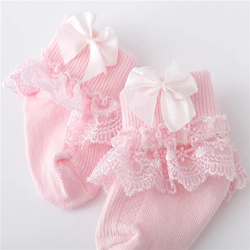 Infant apparel: white lace baby socks with dainty princess bows, perfect for newborn girls