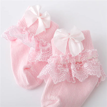 Infant apparel: white lace baby socks with dainty princess bows, perfect for newborn girls