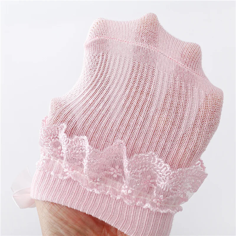 Adorable baby girl's lace socks with prominent princess bows, essential newborn accessory