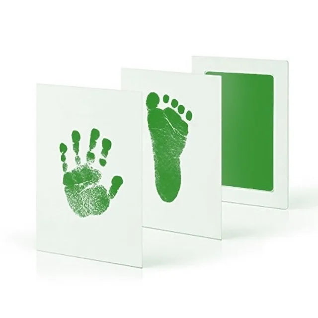 Handprint and footprint kit spread out, featuring ink pad, imprint cards, and instructions for DIY baby memories.