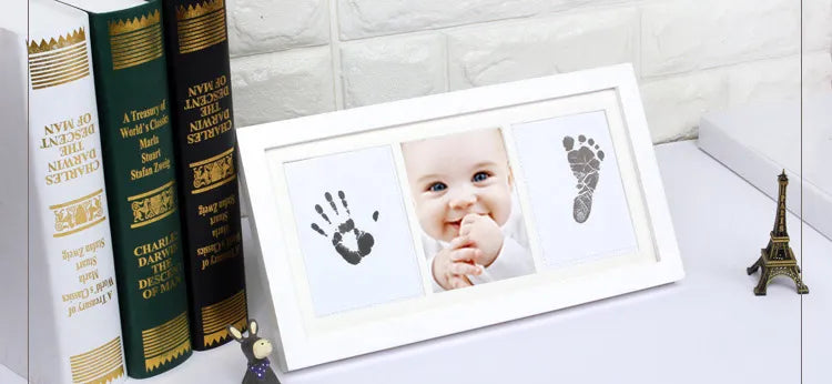 Display of a framed baby handprint and footprint created using the non-toxic ink pad kit