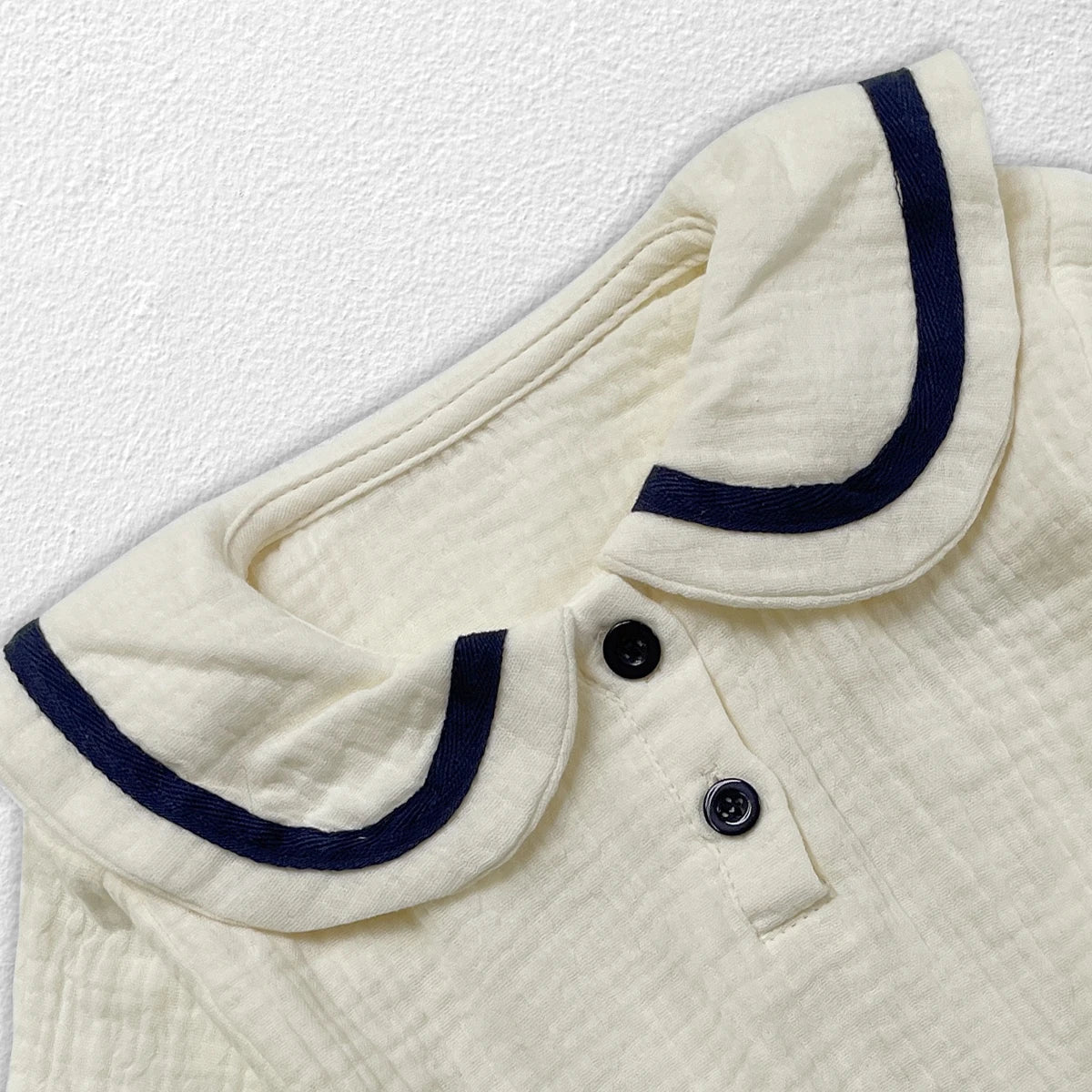 Infant fashion: newborn baby in cozy autumn collar top & bread bottoms outfit.
