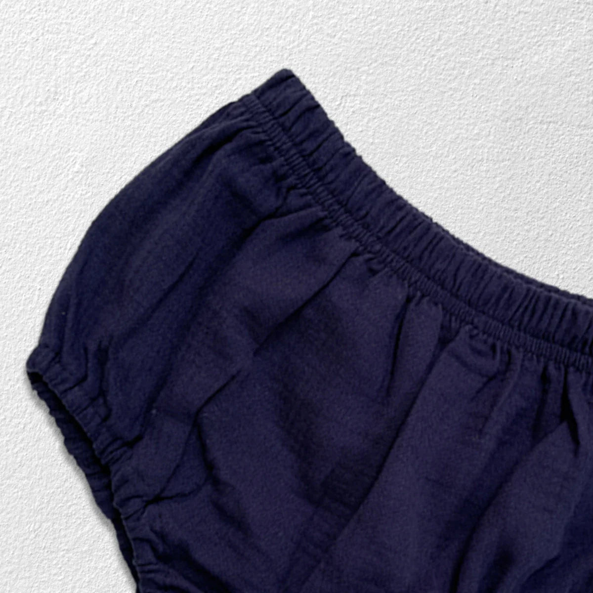 Newborn baby clothes: folded autumn collar top and bread bottoms, ready to wear.