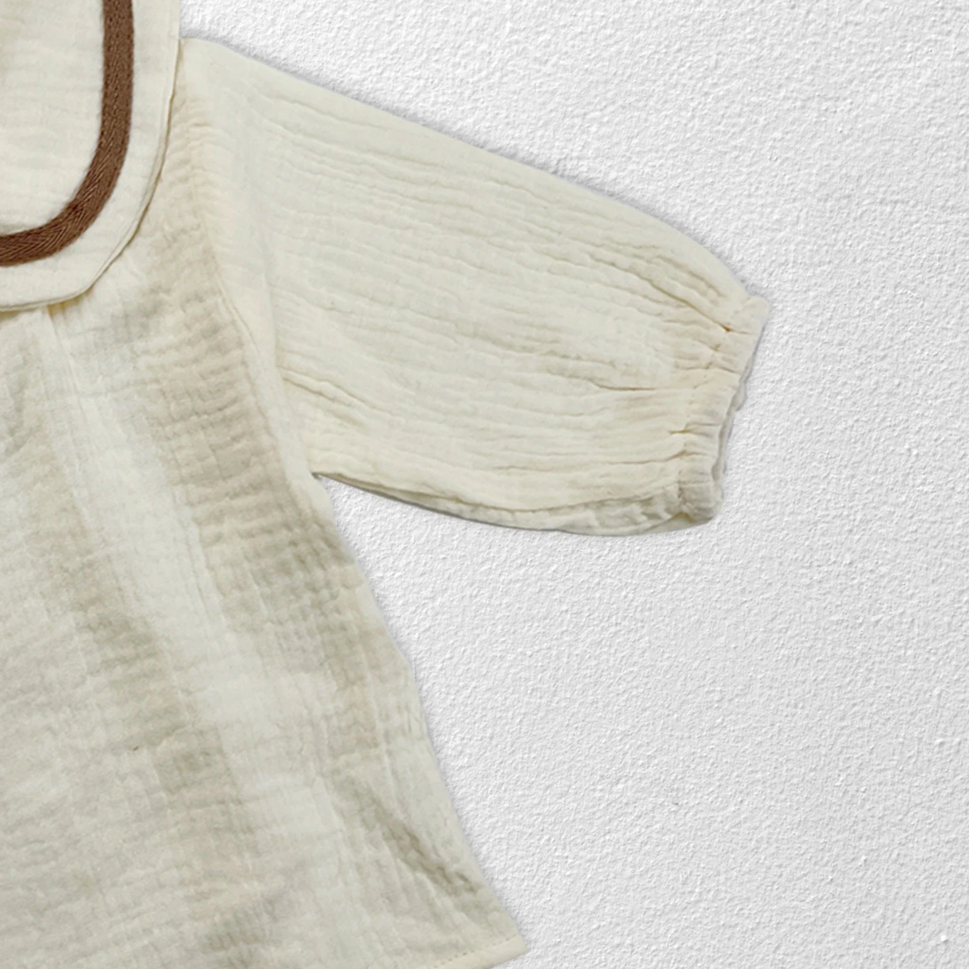 Newborn baby autumn clothing set in lifestyle shot, soft muted tones, infant style.