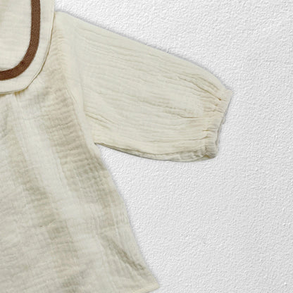 Newborn baby autumn clothing set in lifestyle shot, soft muted tones, infant style.