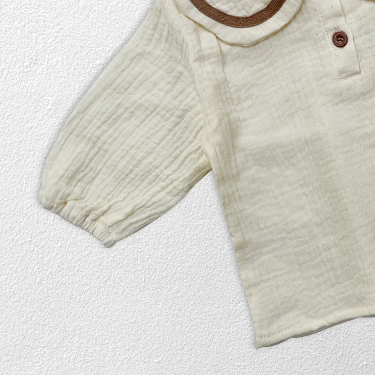Front detail of collar on newborn autumn top, simple yet elegant baby apparel.