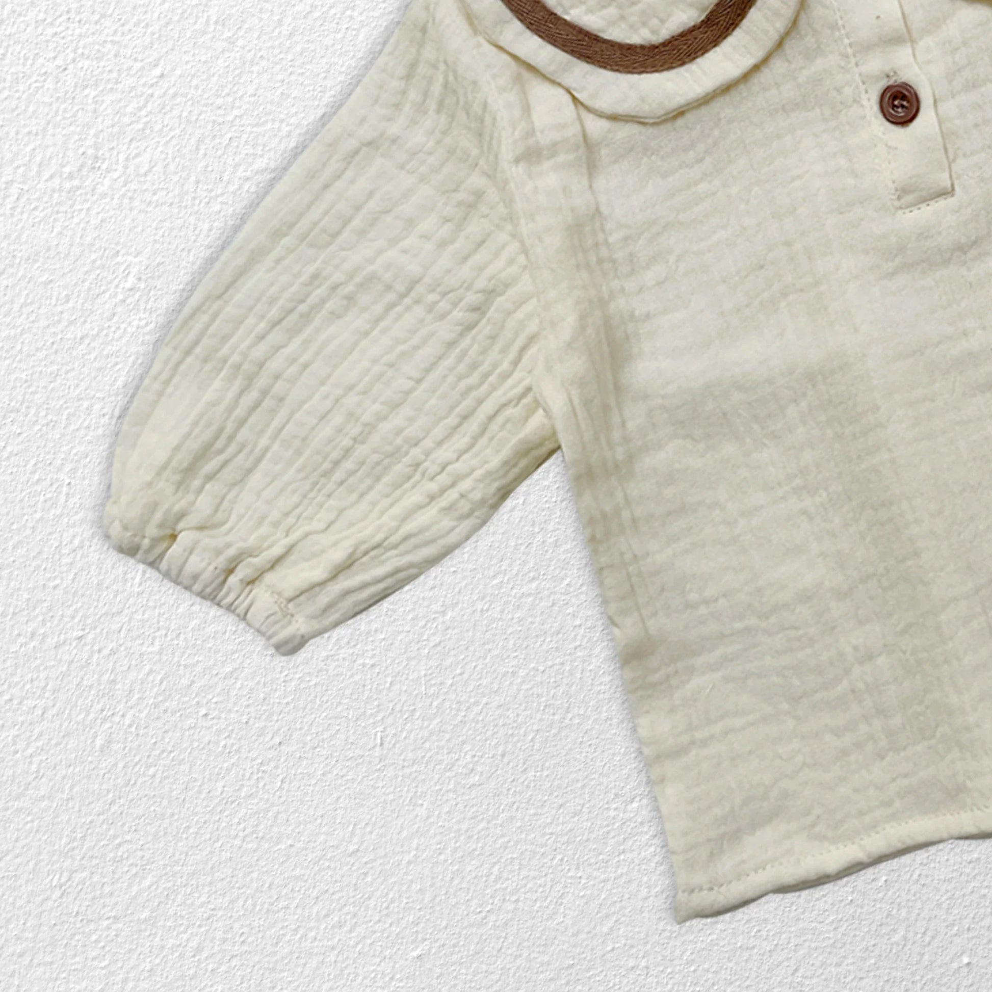 Front detail of collar on newborn autumn top, simple yet elegant baby apparel.