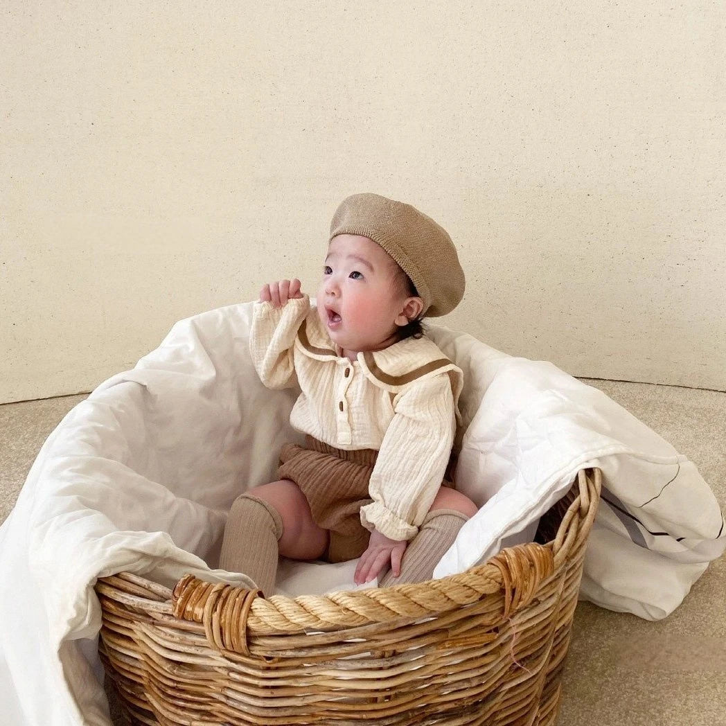 Detail shot of bread bottoms for newborn, textured cotton, comfortable infant clothing.