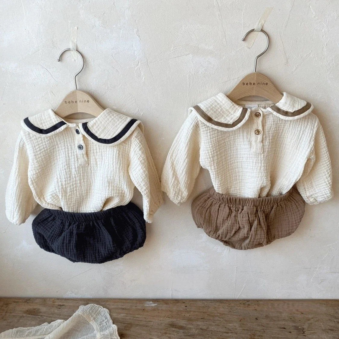 Newborn baby autumn clothing set spread out, showing collar top & bread bottoms.