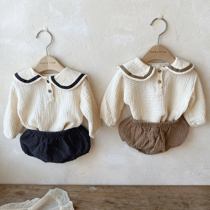 Newborn baby autumn clothing set spread out, showing collar top & bread bottoms.