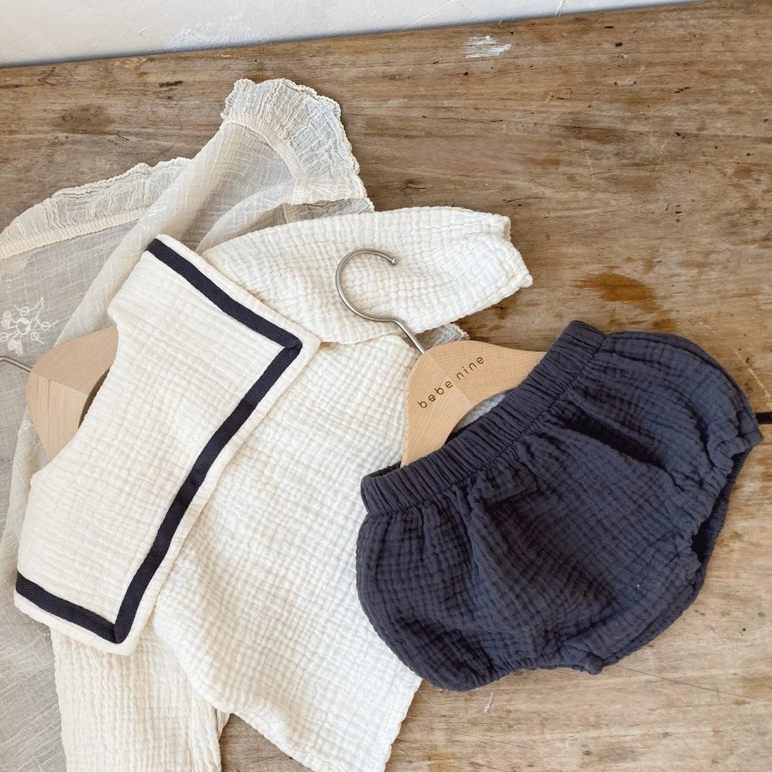 Newborn baby modeling beige cotton autumn collar top and bread bottoms, full body.