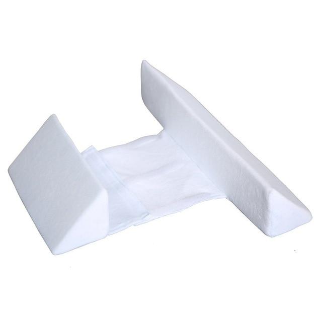 Baby positioner pillow supporting newborns for safe sleep and preventing flat spots on head.