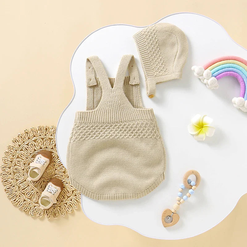 Close-up of sleeveless newborn bodysuit with matching hat, cozy acrylic fabric, baby essentials